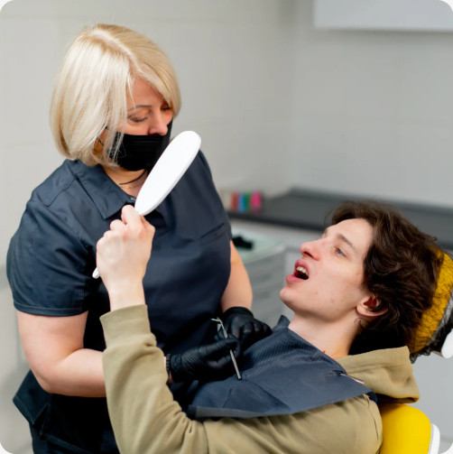 Dentist showing a patient a dental mirror